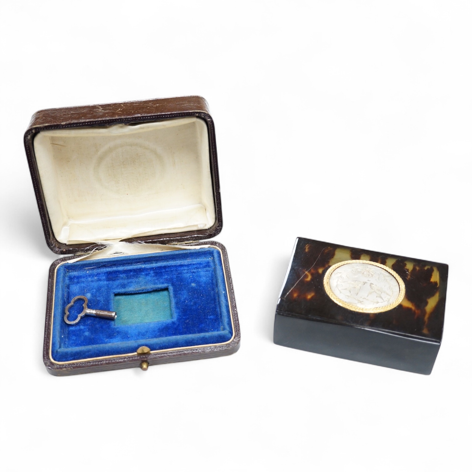 A Victorian white and yellow mounted singing automaton bird music box, damaged, with case and key